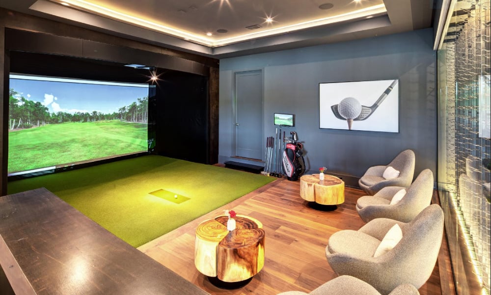 golf simulator room with a comfortable couch for relaxation and enjoying the game