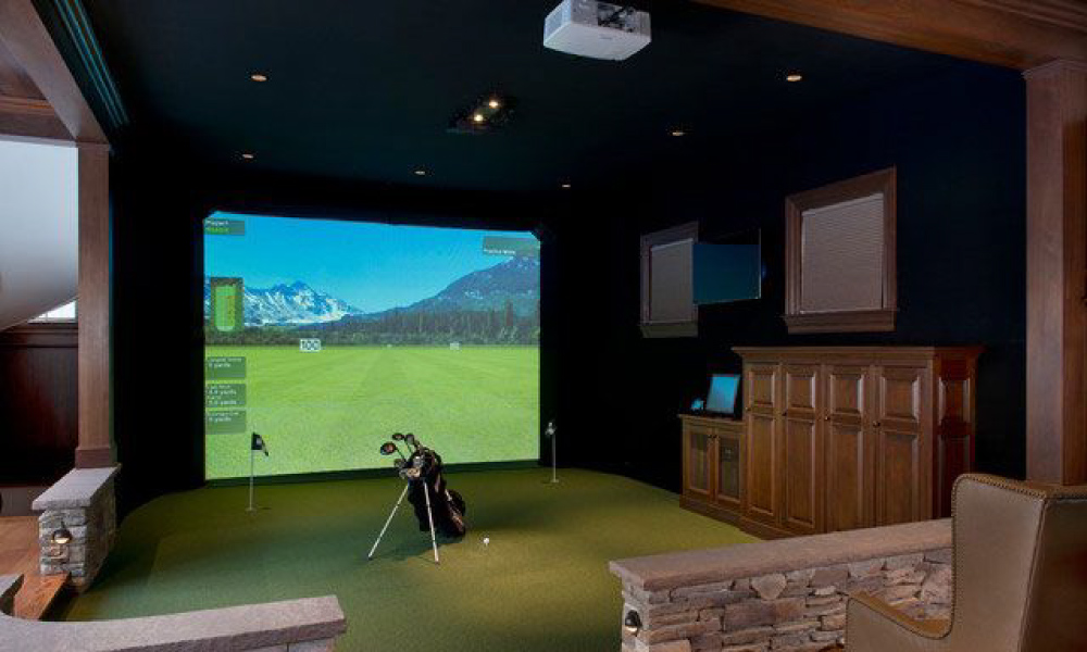 golf simulator room with a rustic and cozy design, featuring reclaimed wood, natural stone, and earth tones