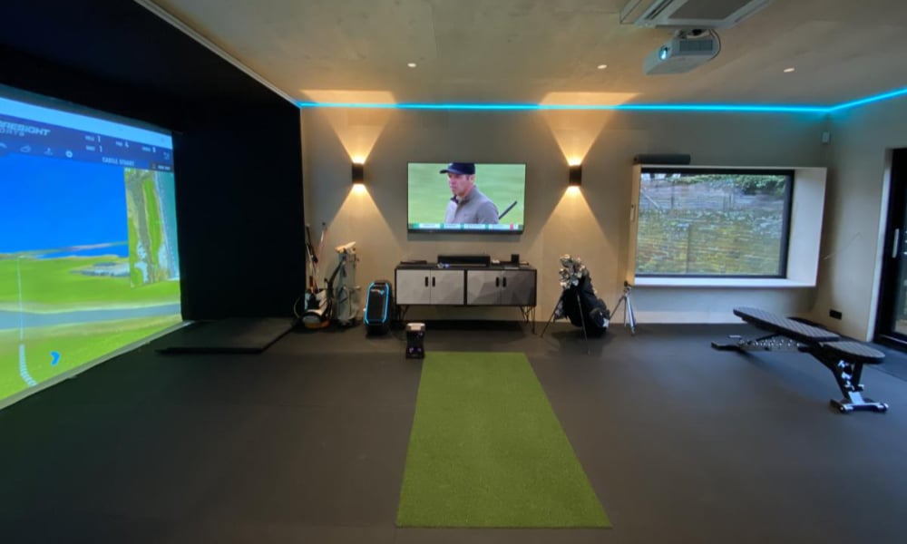 golf simulator room with specialized lighting designed to replicate the lighting conditions of a real golf course